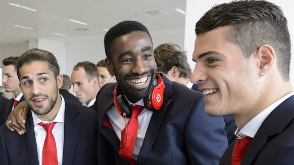 Swiss soccer national team players Yann Sommer, Ricardo Rodriguez, Johan Djourou and Granit Xhaka, from left, smile as they wait for their suitcases at the airport one day ahead the UEFA EURO 2016 qua ...