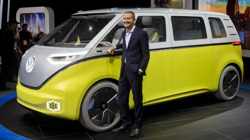 FILE - In a Jan. 9, 2017, file photo, Herbert Diess, chairman of the Volkswagen brand, poses with the I.D. Buzz all-electric concept van, at the North American International Auto Show, in Detroit. The ...