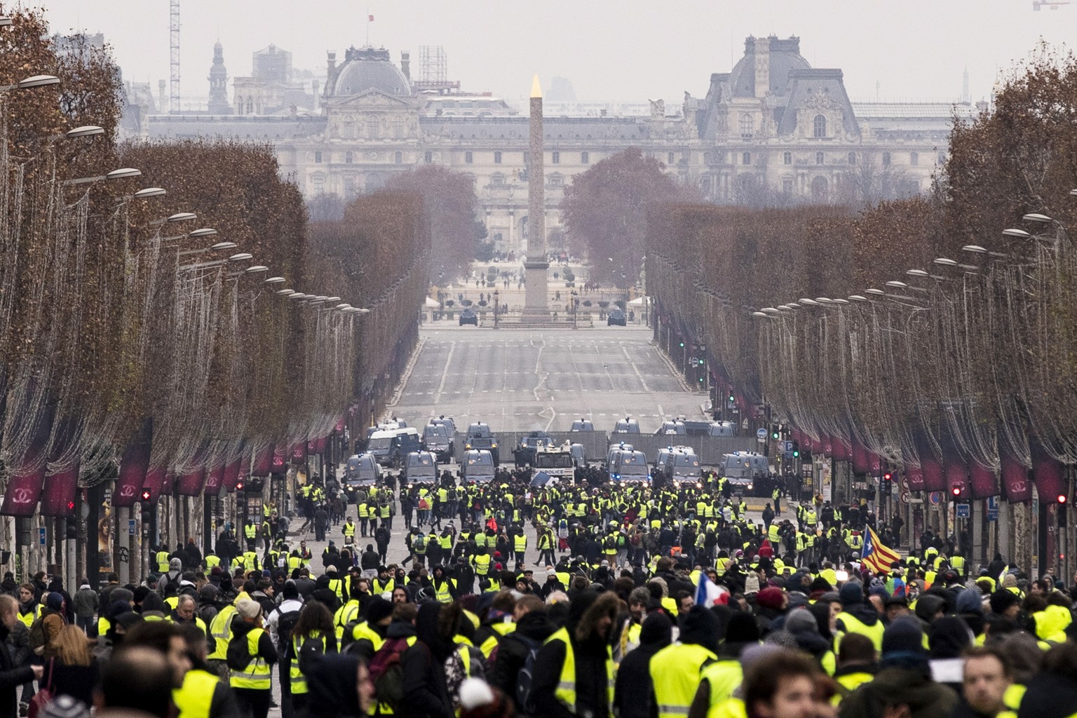 epa07233178 Protesters gather during a Yellow Vest demonstration on the Champs Elysees in Paris, France, 15 December 2018. The so-called &#039;gilets jaunes&#039; (yellow vests) is a protest movement, ...