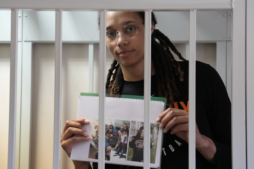 epa10093841 WNBA star and two-time Olympic gold medalist Brittney Griner holds images standing in a cage in a courtroom prior to a hearing at the Khimki City Court outside Moscow, Russia, 27 July 2022 ...