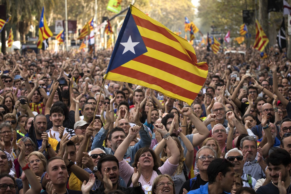 People react as they celebrate the unilateral declaration of independence of Catalonia outside the Catalan Parliament, in Barcelona, Spain, Friday, Oct. 27, 2017. Catalonias' regional Parliament  ...