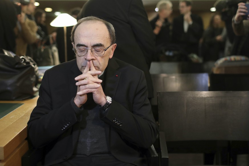 FILE - In this Jan. 7, 2019 file photo, French Cardinal Philippe Barbarin waits for the start of his trial at the Lyon courthouse, central France. A French court has found top Catholic official Cardin ...