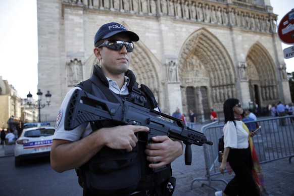 A French police officer patrols in front of Notre Dame cathedral, in Paris, Friday Sept. 9, 2016. A failed attack involving a car loaded with gas canisters near Notre Dame Cathedral was spearheaded a  ...