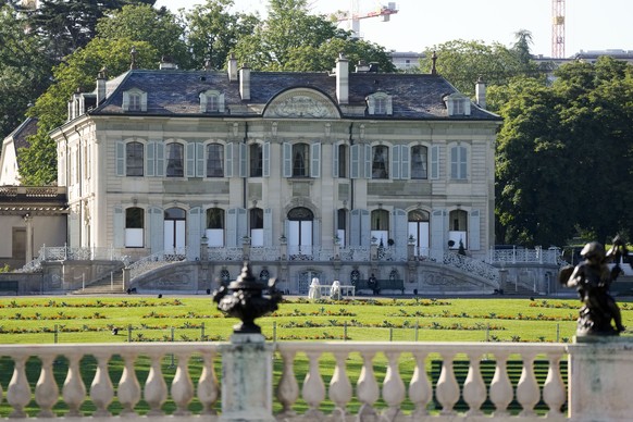 A police officer sits on a bench in in front of the &#039;Villa la Grange&#039; ahead of the meeting of US President Joe Biden and Russian President Vladimir Putin at the villa, in Geneva, Switzerland ...