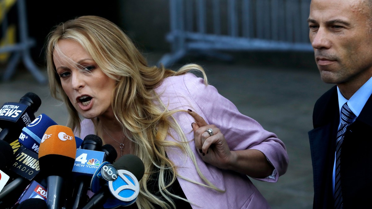 epa06673918 Stormy Daniels (Stephanie Clifford) speaks to the press, as her attorney Michael Avenatti looks on, outside of federal court after a hearing involving President Donald J. Trump's long ...