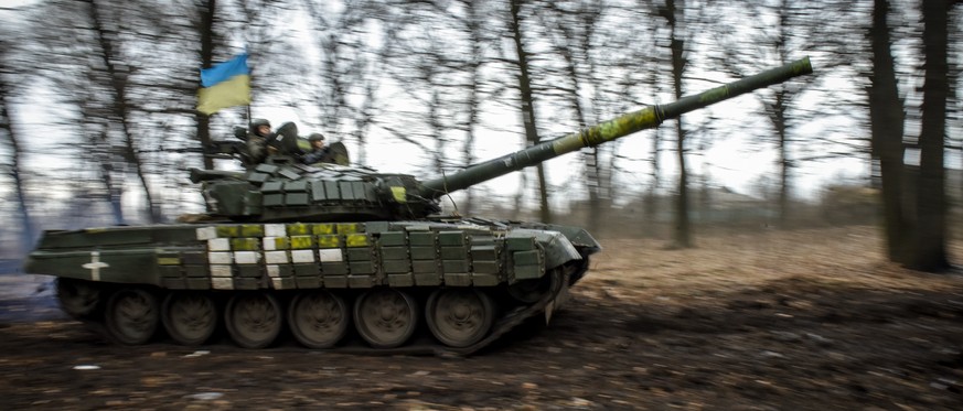 epa10413475 A Ukrainian T-72 tank manoeuvers through the trees in the Donetsk region, eastern Ukraine, 18 January 2023. Britain?s defence secretary Ben Wallace confirmed on Monday that the UK would se ...