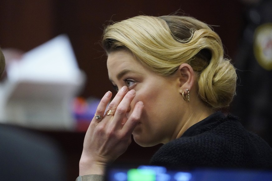 Actor Amber Heard listens in the courtroom at the Fairfax County Circuit Courthouse in Fairfax, Va., Monday, April 25, 2022. Actor Johnny Depp sued his ex-wife Amber Heard for libel in Fairfax County  ...