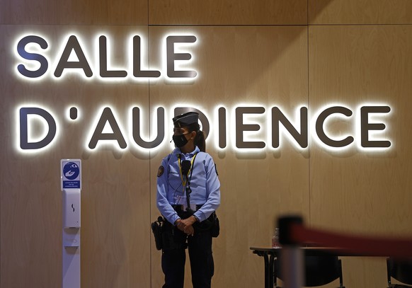 epa09454619 A policewoman stands in front the courtroom of the trial for the 2015 Paris attacks, at a courthouse in Paris, France, 08 September 2021. The trial over the 13 November 2015 terrorist atta ...