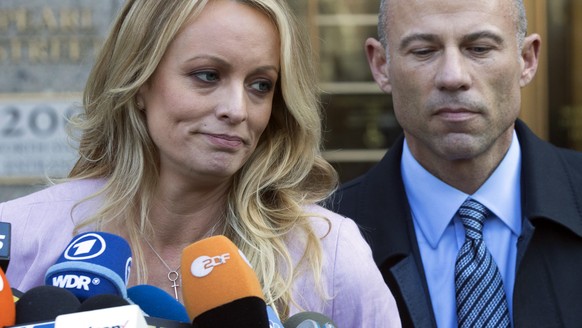 Adult film actress Stormy Daniels, left, stands with her lawyer Michael Avenatti as she speaks outside federal court, Monday, April 16, 2018, in New York. (AP Photo/Mary Altaffer)