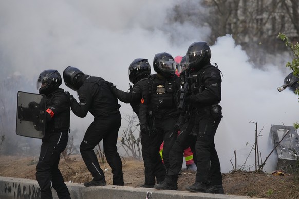 Members of the BRAV unit of riot police advance after a demonstration on Tuesday, March 28, 2023 in Paris.  It's the latest round of nationwide demonstrations and strikes against unpopular pens...