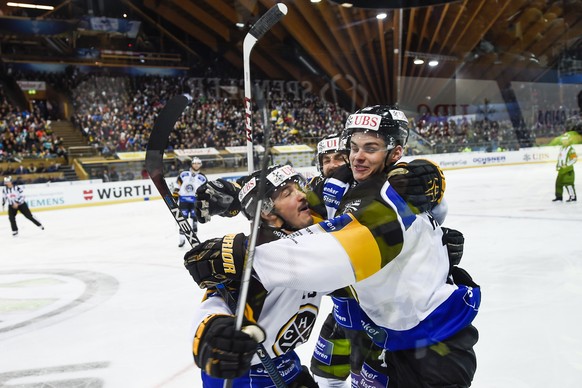 Lugano&#039; Alessio Bertaggia, Gregory Hofmann and Dan Spang, from left, celebrates after Hofmann scored 0-1 against Team Canada&#039;s Jeff Glass, during the final game between Team Canada and Switz ...