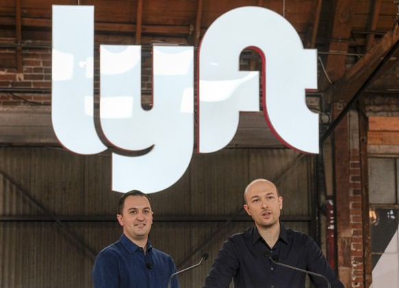 FILE - Lyft co-founders John Zimmer, left, and Logan Green speak before they ring a ceremonial opening bell in Los Angeles on March 29, 2019. The Lyft co-founders are relinquishing their leadership ro ...