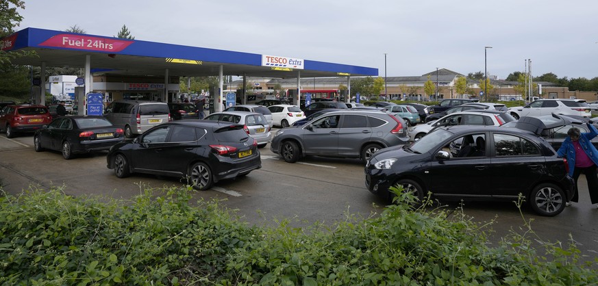 Drivers queue for fuel at a petrol station in London, Thursday, Sept. 30, 2021. Many gas stations around Britain have shut down in the past five days after running out of fuel, a situation exacerbated ...