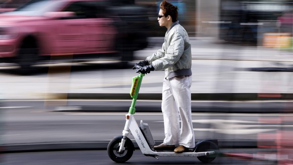 epa11923954 A person rides a Lime rental e-scooter in central London, Britain, 25 February 2025. Westminster council will convert around 200 car parking spaces in central London into parking bays for  ...