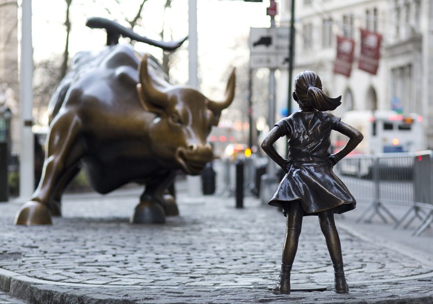 In this March 22, 2017 photo, the Charging Bull and Fearless Girl statues are sit on Lower Broadway in New York. Since 1989 the bronze bull has stood in New York City's financial district as an image  ...