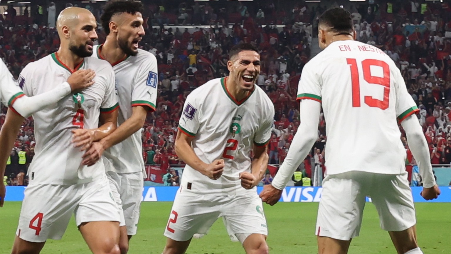 epa10341860 Youssef En-Nesyri (R) of Morocco celebrates with teammates after scoring the side&#039;s second goal during the FIFA World Cup 2022 group F soccer match between Canada and Morocco at Al Th ...