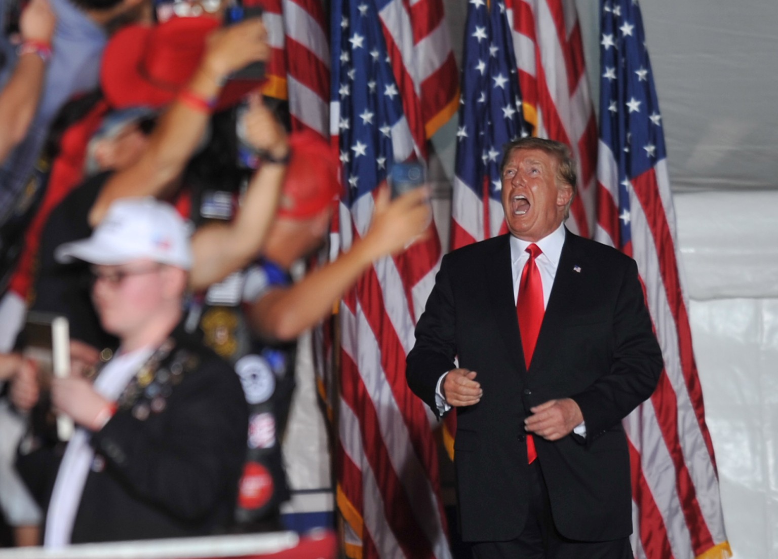 epaselect epa09515989 Former US President Donald J. Trump gestures to supporters at a Save America rally at the Iowa State Fairgrounds in Des Moines, Iowa, USA, 09 October 2021. The rally highlights T ...