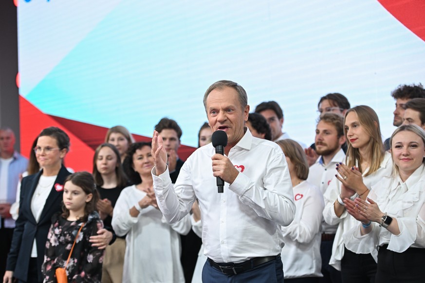 epa10920949 Leader of main opposition party Civic Platform (PO) Donald Tusk (C) speaks during Law and Justice party parliamentary elections night in Warsaw, Poland, 15 October 2023. Parliamentary elec ...