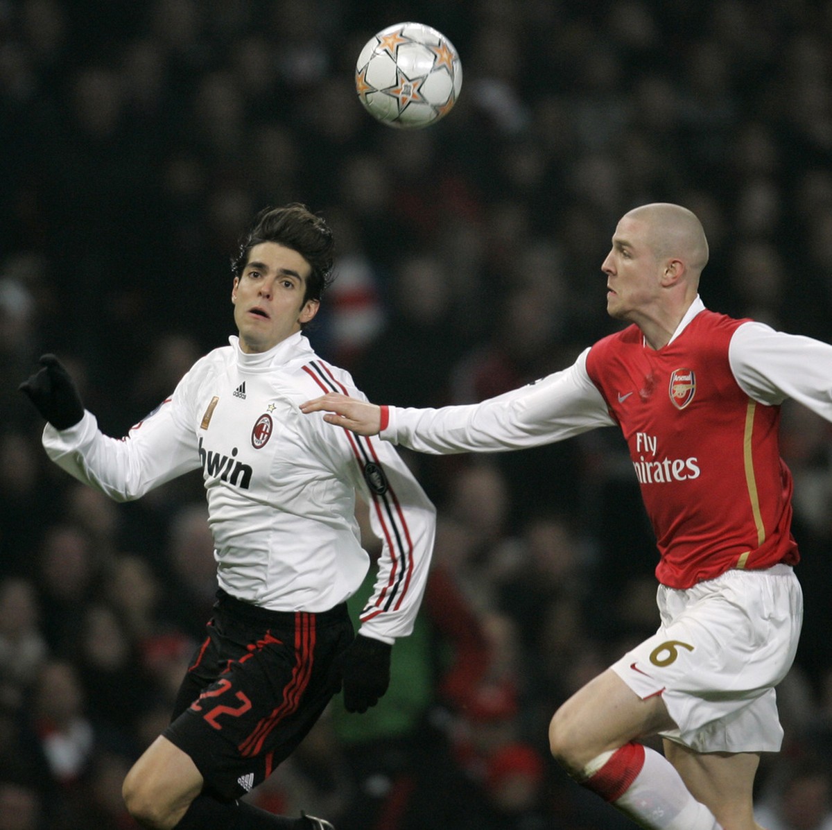 AC Milan's Kaka, left, vies for the ball with Arsenal's Philippe Senderos, right, during their Champions League round of 16 soccer match at the Emirates Stadium in London, Wednesday, Feb. 20 ...