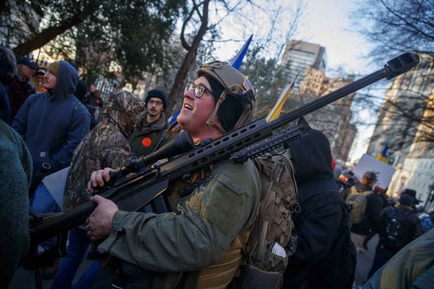 epa08144558 Gun-rights supporters gather for a rally outside the Virginia state capitol in Richmond, Virginia, USA, 20 January 2020. Virginia Citizens Defense League organized the rally to lobby again ...