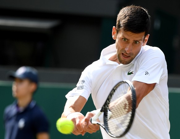 epa07703919 Novak Djokovic of Serbia in action against Ugo Humbert of France during their fourth round match for the Wimbledon Championships at the All England Lawn Tennis Club, in London, Britain, 08 ...