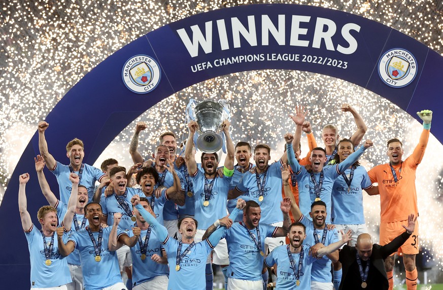 epaselect epa10684397 Manchester City captain Ilkay Guendogan raises the trophny as the team celebrate winning the UEFA Champions League Final soccer match between Manchester City and Inter Milan, in  ...
