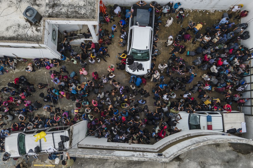 Migrants crowd into the patio at the Attorney Generals office after they were intercepted from inside cargo trailer trucks driving on the highway, in Coatzacoalcos, Veracruz state, Mexico, Friday, Nov ...