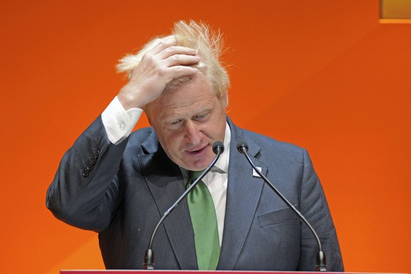 British Prime Minister Boris Johnson adjusts his hair as he speaks at the the Commonwealth Business Forum at the ICC in Birmingham, England, Thursday, July 28, 2022. (Peter Byrne/Pool Photo via AP)