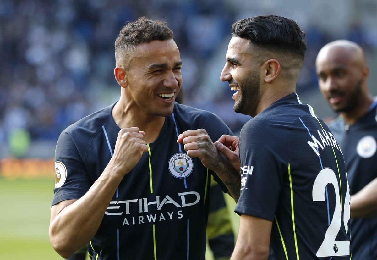 Manchester City's Danilo and Riyad Mahrez, right, celebrate at the end of the English Premier League soccer match between Brighton and Manchester City at the AMEX Stadium in Brighton, England, Su ...