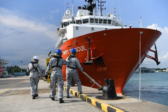 In this Apr. 21, 2021, photo, personnel from the Republic of Singapore Navy cast off lines of the MV Swift Rescue, a submarine support and rescue vessel, before being dispatched for Indonesia from Sin ...