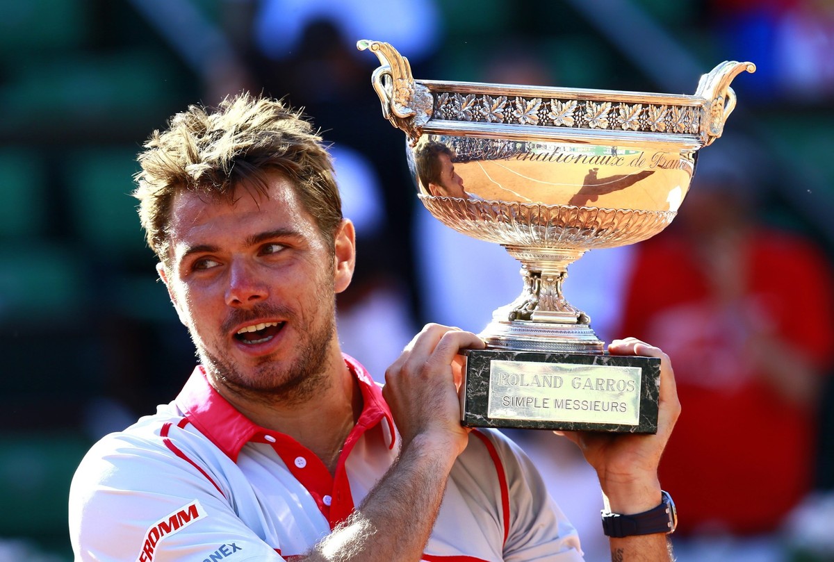 epa04788261 Stan Wawrinka of Switzerland poses with the winner's trophy after beating Novak Djokovic of Serbia in the men's final match for the French Open tennis tournament at Roland Garros ...