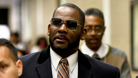 FILE - Musician R. Kelly, center, leaves the Daley Center after a hearing in his child support case on May 8, 2019, in Chicago. Closing arguments are scheduled Monday, Sept. 12, 2022 for R. Kelly and  ...