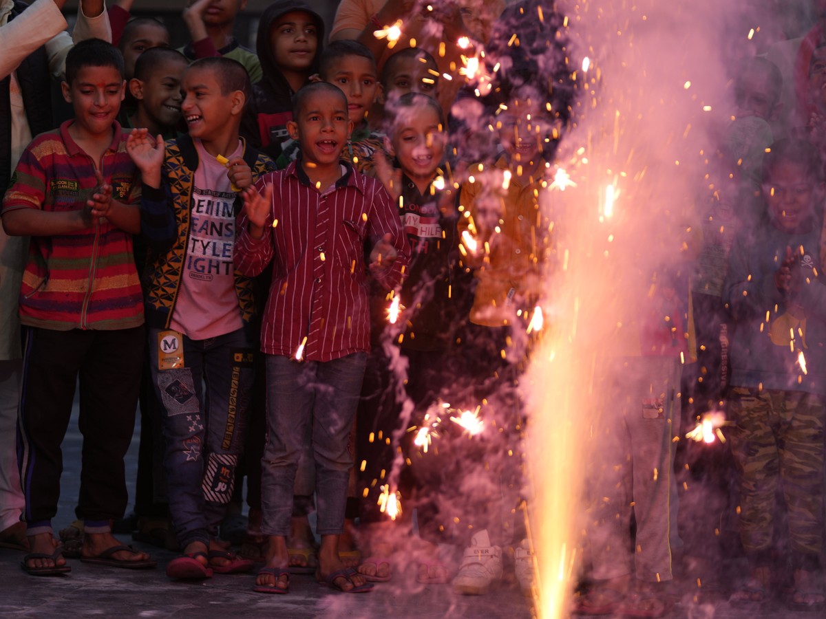 Children play with firecrackers on the eve of Diwali, the Hindu festival of lights, at an orphanage in Jammu, India, Sunday, Oct.23, 2022. (AP Photo/Channi Anand)