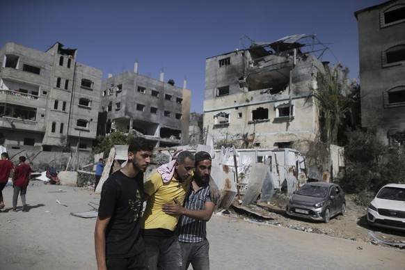 Palestinians help a wounded man after Israeli strikes in Nuseirat refugee camp, Gaza Strip, Saturday, June 8, 2024. (AP Photo/Jehad Alshrafi)