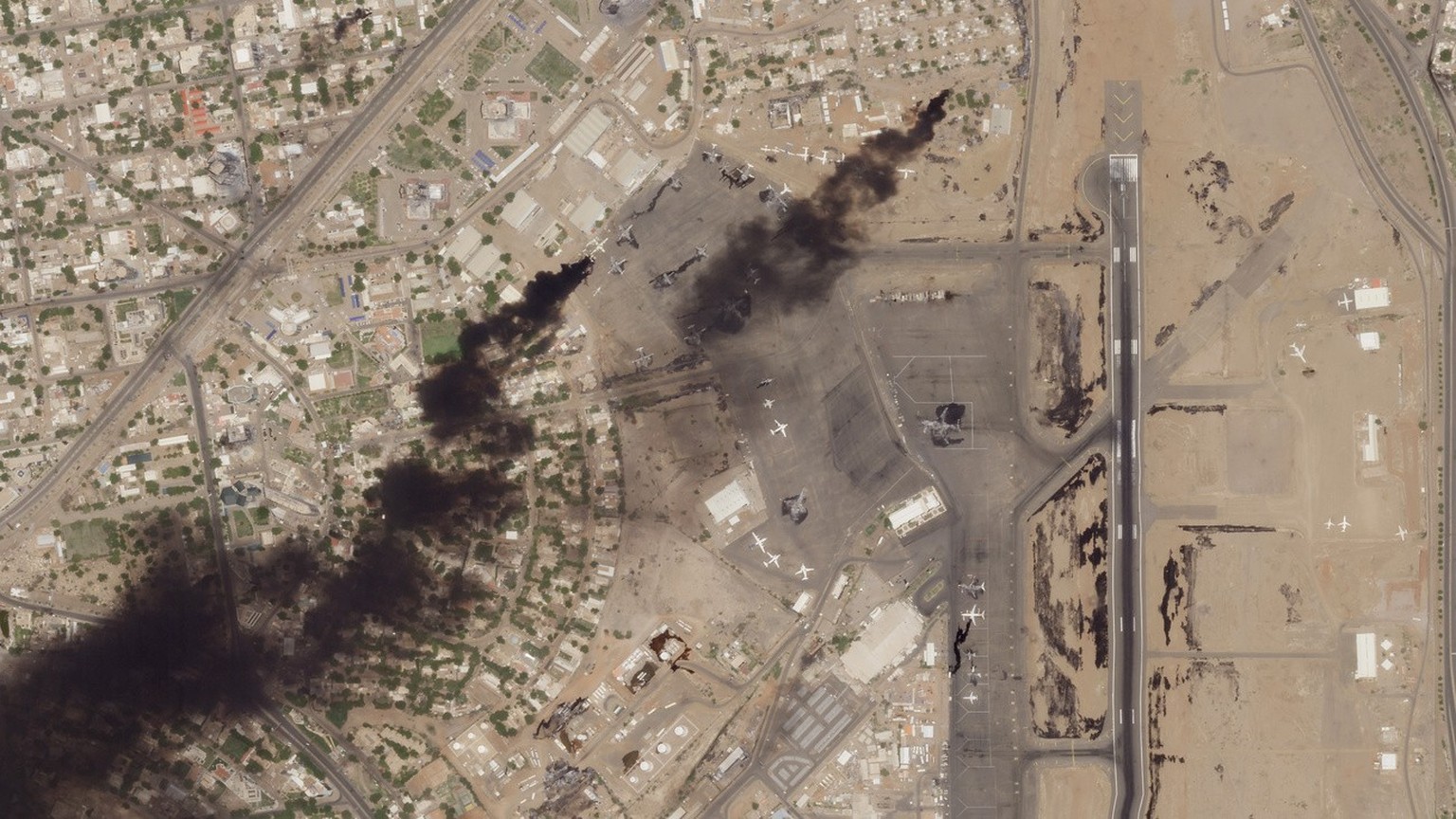 This satellite photo from Planet Labs PBC shows fires burning at Khartoum International Airport in Khartoum, Sudan, Wednesday, April 19, 2023. Explosions and heavy gunfire rattled the Sudanese capital ...