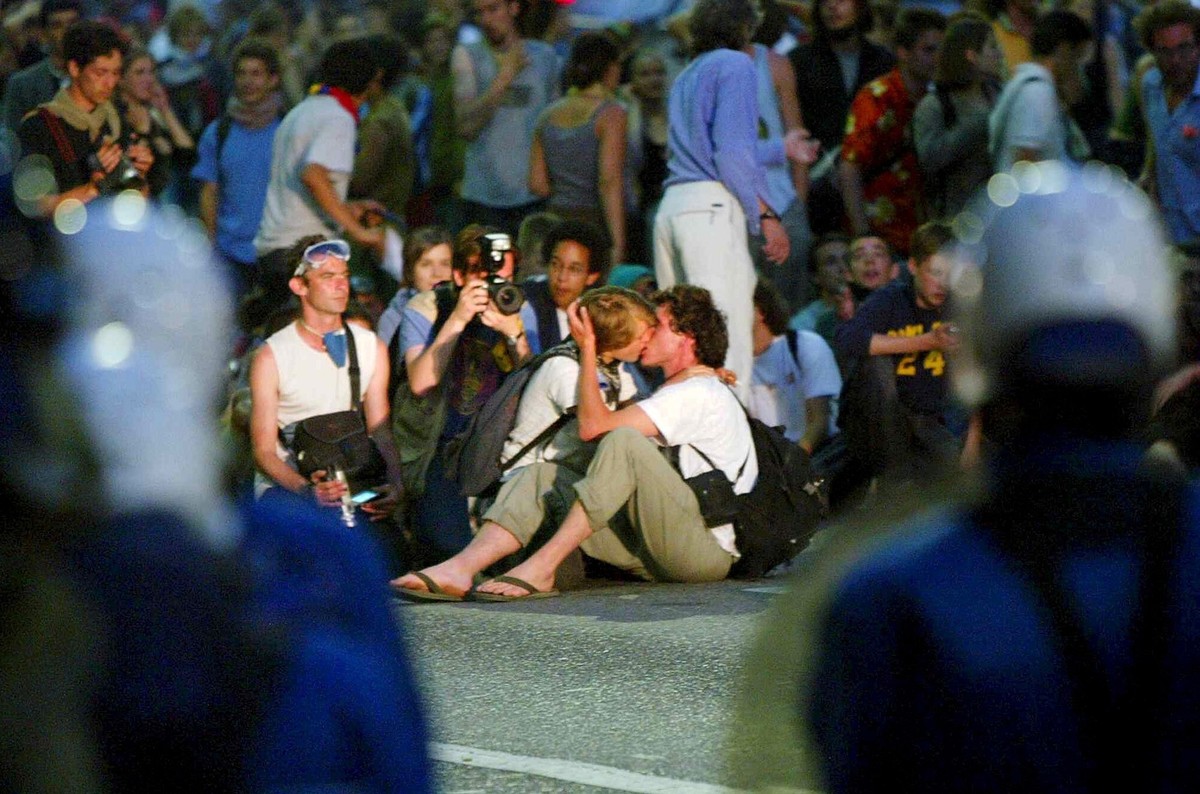 Two protesters kiss in front of Geneva riot police in Geneva, Switzerland, Monday night, June 2, 2003. After heavy riots on Saturday and Sunday, demonstrators continued to show their displeasures with ...