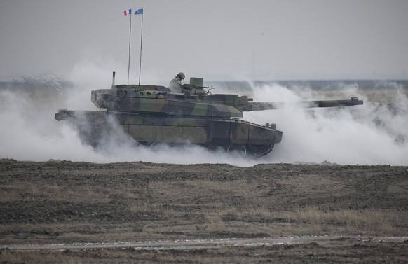 A French Leclerc main battle tank is engulfed by smoke during an exercise at a training ground in Smardan, eastern Romania, Wednesday, January 25, 2023. About 600 French soldiers deployed to Romania as p...