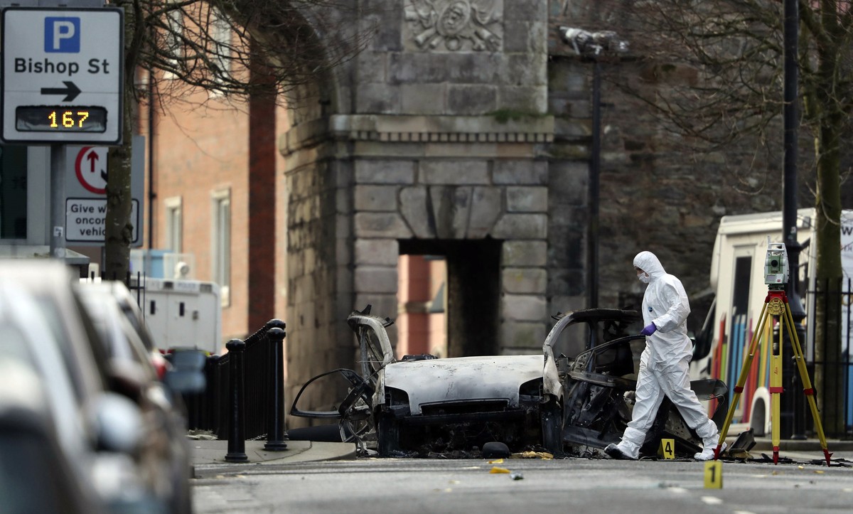 Forensic investigators at the scene of a car bomb blast on Bishop Street in Londonderry, Northern Ireland, Sunday, Jan. 20, 2019. Northern Ireland police and politicians have condemned a "reckles ...