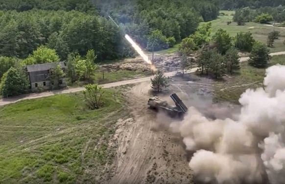 In this handout photo by Russian Defense Ministry Press Service released on Saturday, June 25, 2022, a Russian military&#039;s multiple rocket launcher fires rockets at Ukrainian troops at an undisclo ...