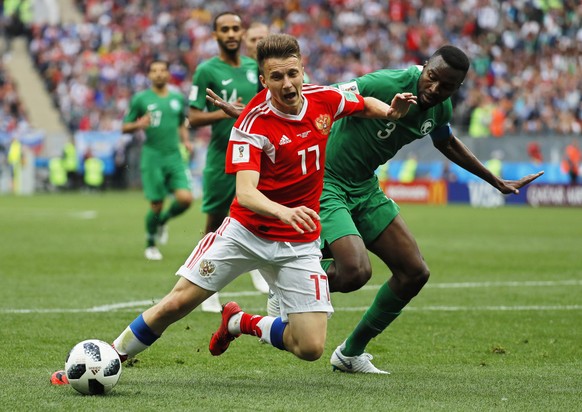 epa06807548 Aleksandr Golovin (L) of Russia in action against Osama Hawsawi (R) of Saudi Arabia during the FIFA World Cup 2018 group A preliminary round soccer match between Russia and Saudi Arabia in ...