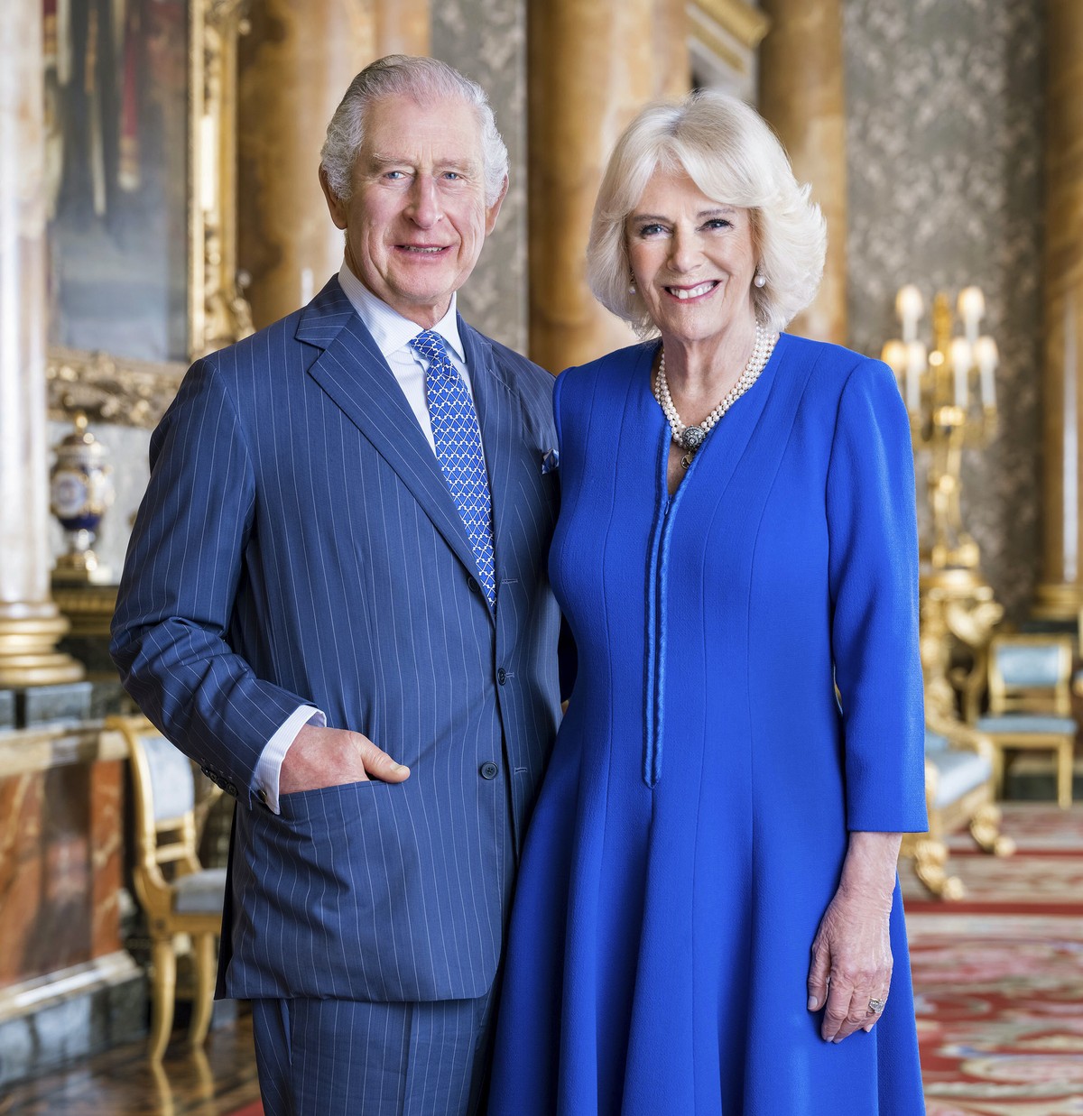 In this photo provided by Buckingham Palace on Tuesday, April 4, 2023, Britain's King Charles III and Camilla, the Queen Consort pose for a photo in the Blue Drawing Room at Buckingham Palace, Lo ...