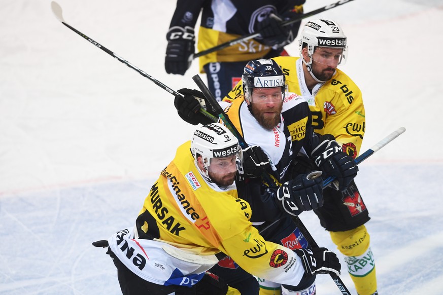 From left, Bern&#039;s player Jan Mursak, Ambri&#039;s player Mattia Jiri Novotny and Bern&#039;s player Vincent Praplan, during the preliminary round game of National League A (NLA) Swiss Championshi ...