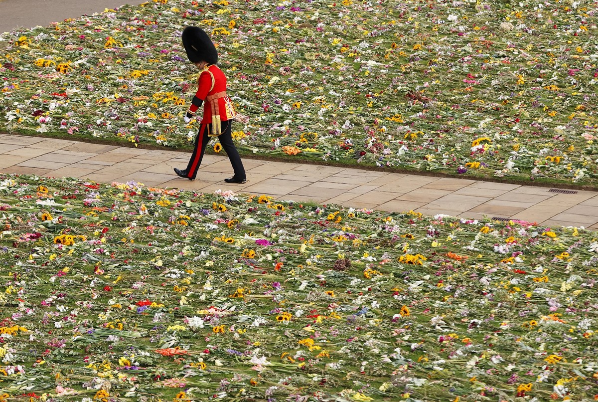 WINDSOR, ENGLAND - SEPTEMBER 19: A member of the Coldstream Guards is seen walking past a bed of flowers during the State Funeral of Queen Elizabeth II on September 19, 2022 in London, England. Elizab ...