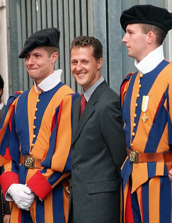 German formula one ace Michael Schumacher, flanked by two Swiss Guards, is all smiles during a special audience in St. Peter&#039;s square at the Vatican Wednesday, October 5 1999. (AP Photo/Plinio Le ...