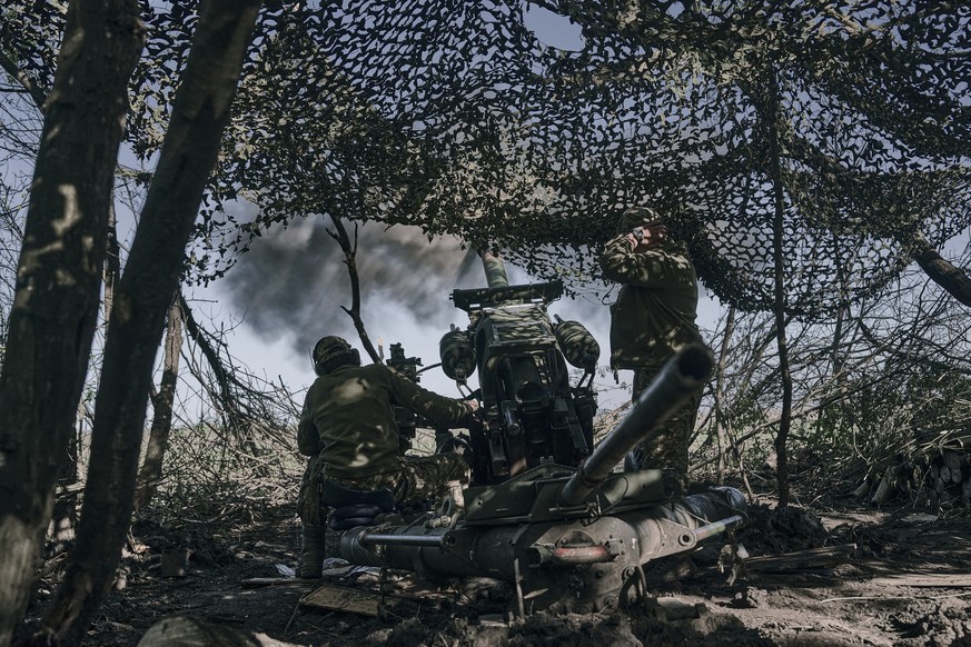 FILE - Ukrainian soldiers fire a cannon near Bakhmut, an eastern city where fierce battles against Russian forces have been taking place, in the Donetsk region, Ukraine, Wednesday, May 3, 2023. The ow ...