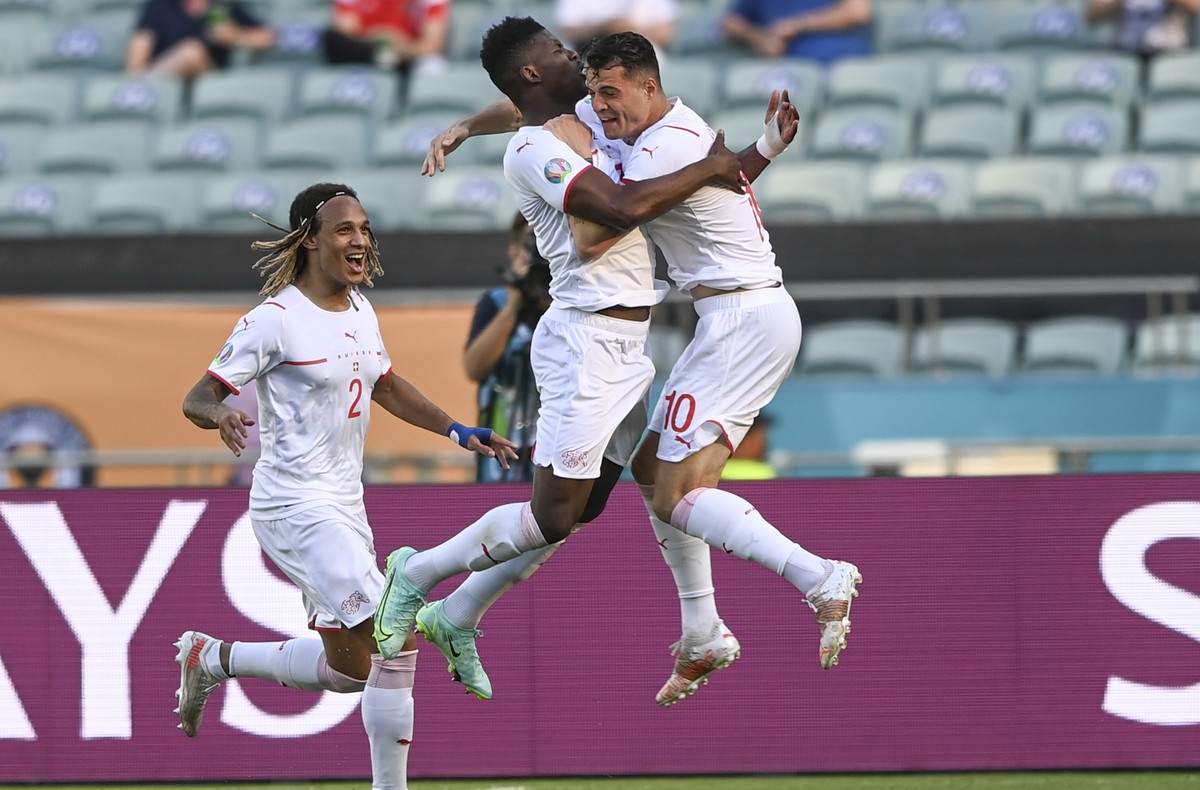 Switzerland's Breel Embolo celebrates with Granit Xhaka, right, after scoring his side's opening goal during the Euro 2020 soccer championship group A match between Wales and Switzerland, at ...
