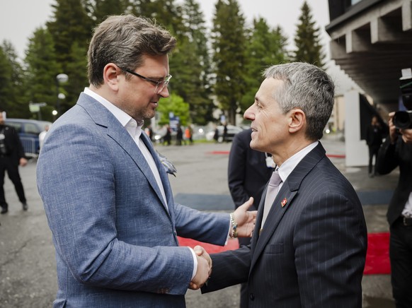 epa09972875 Ignazio Cassis (R), President of the Swiss Confederation, shakes hand with Dmytro Kuleba (L), Minister of Foreign Affairs of Ukraine, during the 51st annual meeting of the World Economic F ...