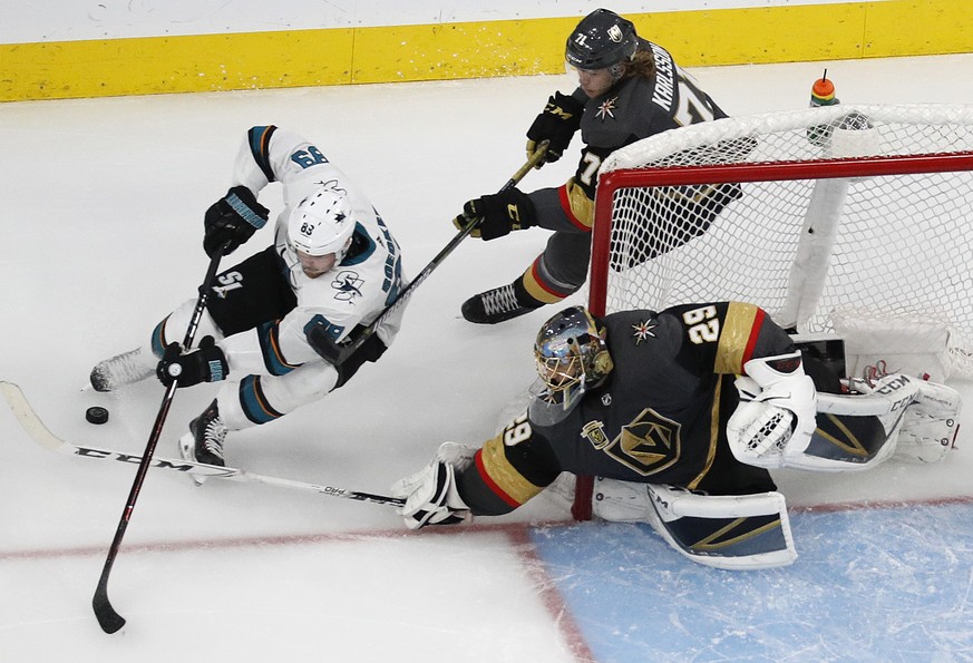 Vegas Golden Knights goaltender Marc-Andre Fleury (29) knocks the puck away from San Jose Sharks left wing Mikkel Boedker (89) during the first overtime of Game 2 of an NHL hockey second-round playoff ...