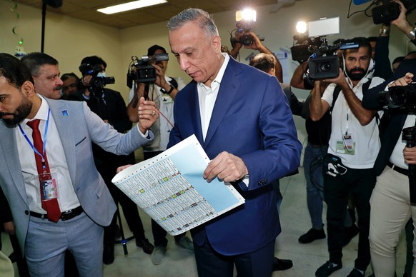 Iraqi Prime Minister Mustafa al-Kadhimi casts his vote during parliamentary elections in Baghdad, Iraq, Sunday, Oct. 10, 2021. Iraq closed its airspace and land border crossings on Sunday as voters he ...