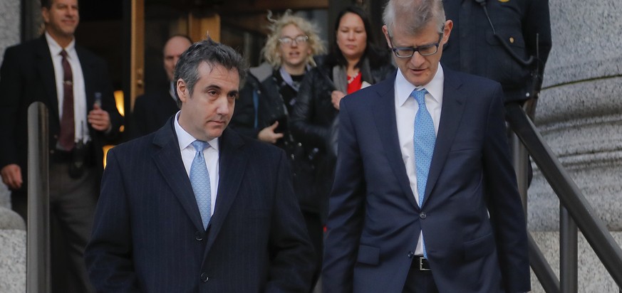 Michael Cohen, left, walks out of federal court with his attorney Guy Petrillo, Thursday, Nov. 29, 2018, in New York. Cohen, President Donald Trump&#039;s former lawyer, pleaded guilty to lying to Con ...